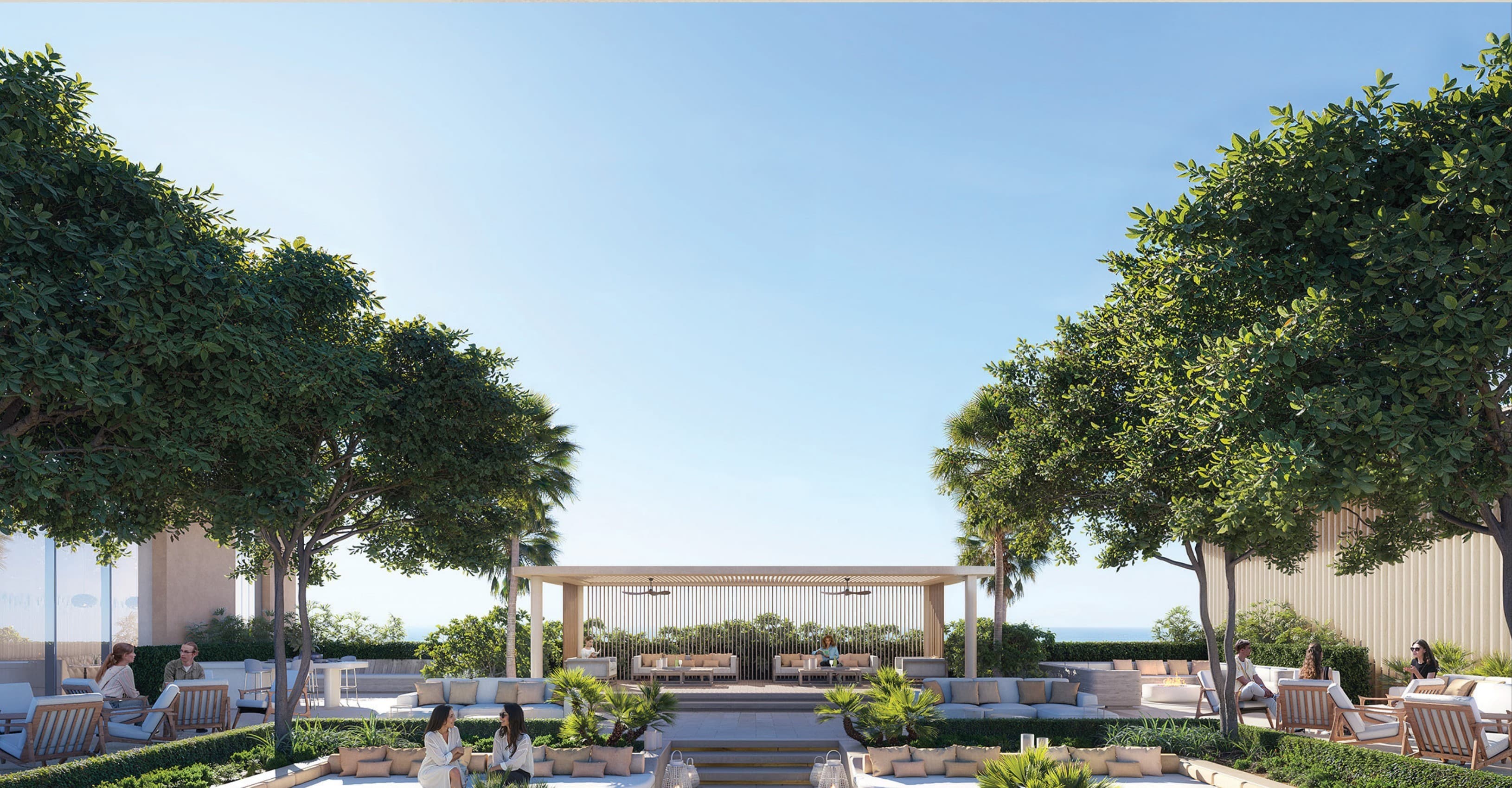 Rooftop sky pavilion with a shaded lounge, gardens and the sea beyond